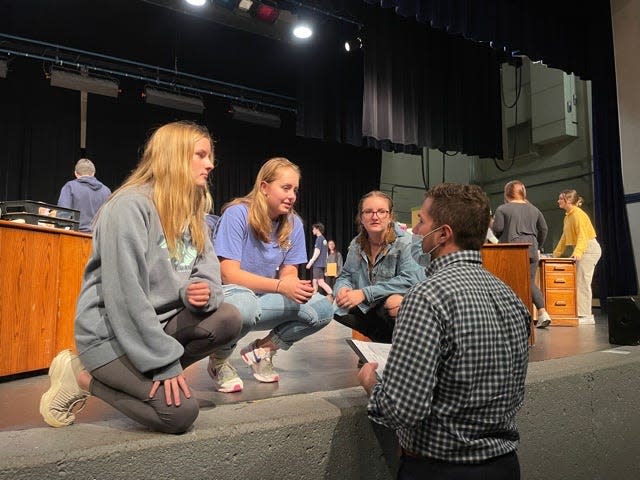 Mary Claire Carter, Hannah Liske and Meghan Tucker take notes from vocal director Mitchell Moore at a rehearsal for an upcoming production of “9 to 5” held at Farragut High School Tuesday, Nov. 23, 2021.