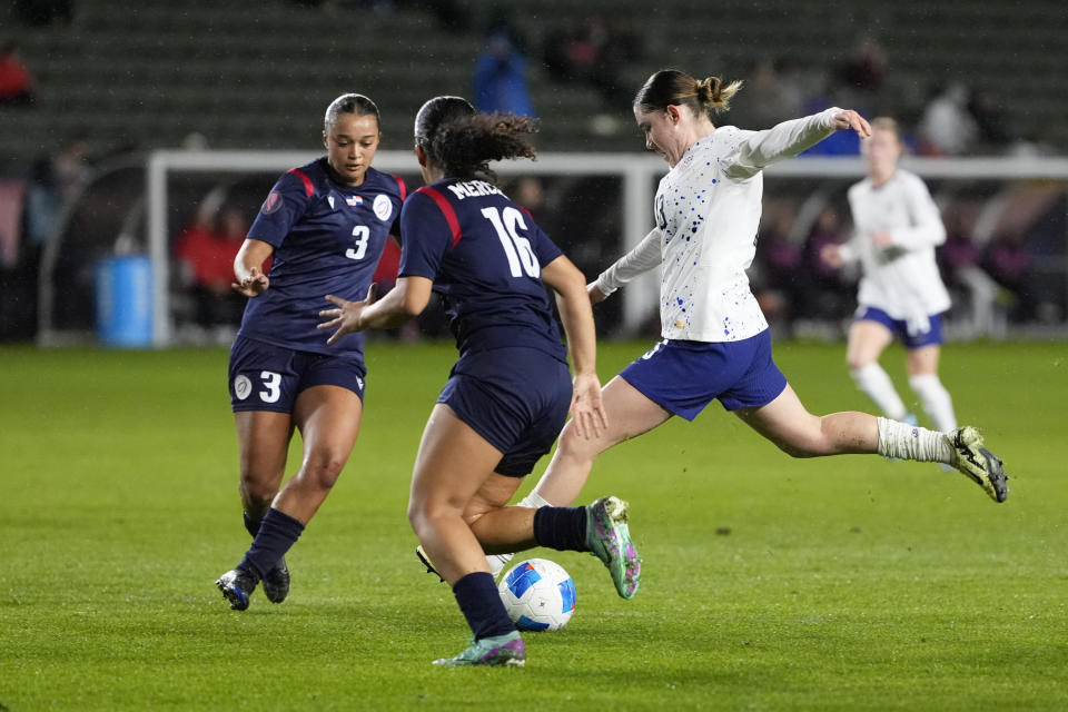 United States' Olivia Moultrie (13) shoots the ball against Dominican Republic's Stella Tapia (3) and Renata Mercerdes (16) during the first half of the CONCACAF Women’s Gold Cup soccer tournament at Dignity Health Sports Park in Carson, Calif., Tuesday, Feb. 20, 2024. (AP Photo/Damian Dovarganes)