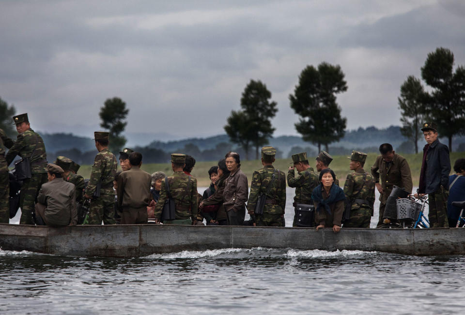 <p>North Koreans ride on a boat used as a local ferry as they cross the Yalu river north of the border city of Dandong, Liaoning province, northern China near Sinuiju, North Korea on May 23, 2017 in Dandong, China. (Photo: Kevin Frayer/Getty Images)Images) </p>