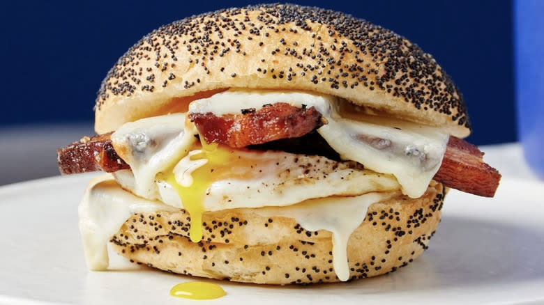 Bacon egg and cheese on a poppyseed bun