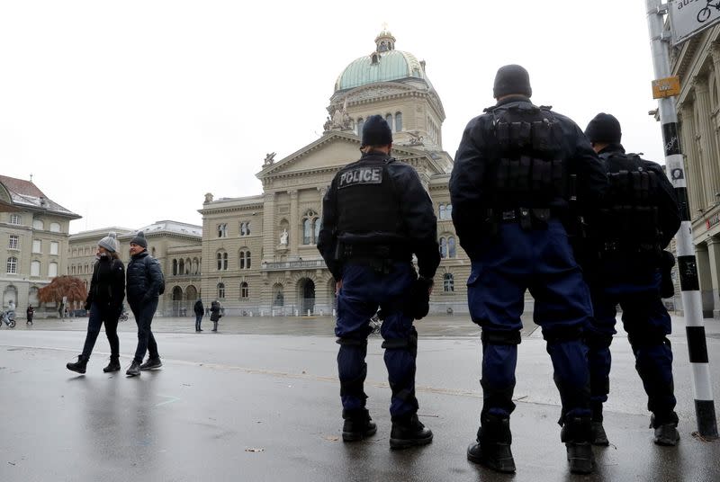 Police officers stand guard in front of Swiss Federal Palace in Bern