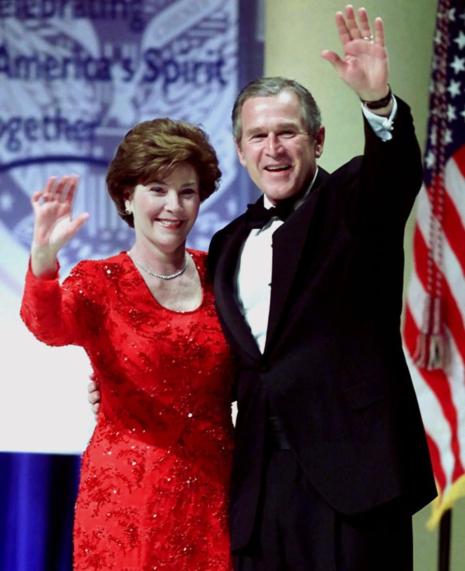 President Bush and his wife Laura Bush wave to the crowd after sharing a dance at the Ohio Inaugural Ball in Washington, D.C. on Saturday, Jan. 20, 2001. (AP Photo/Amy Sancetta)