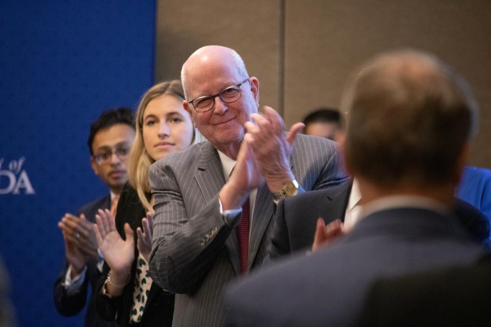 University of Florida trustee Richard Cole claps for President Kent Fuchs during the UF board of trustees confirmation hearing on Sen. Ben Sasse at Emerson Hall in Gainesville on Tuesday.