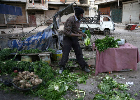 A man is seen at a damaged site after an airstrike in the rebel-held besieged town of Douma, eastern Ghouta in Damascus, Syria, November 27, 2017. REUTERS/Bassam Khabieh