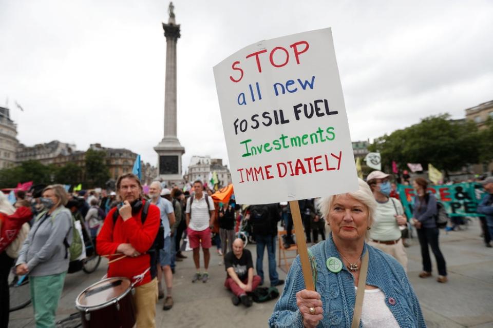 A demonstrator holds a sign during a protest of Extinction Rebellion climate activists at Trafalgar Square (REUTERS)