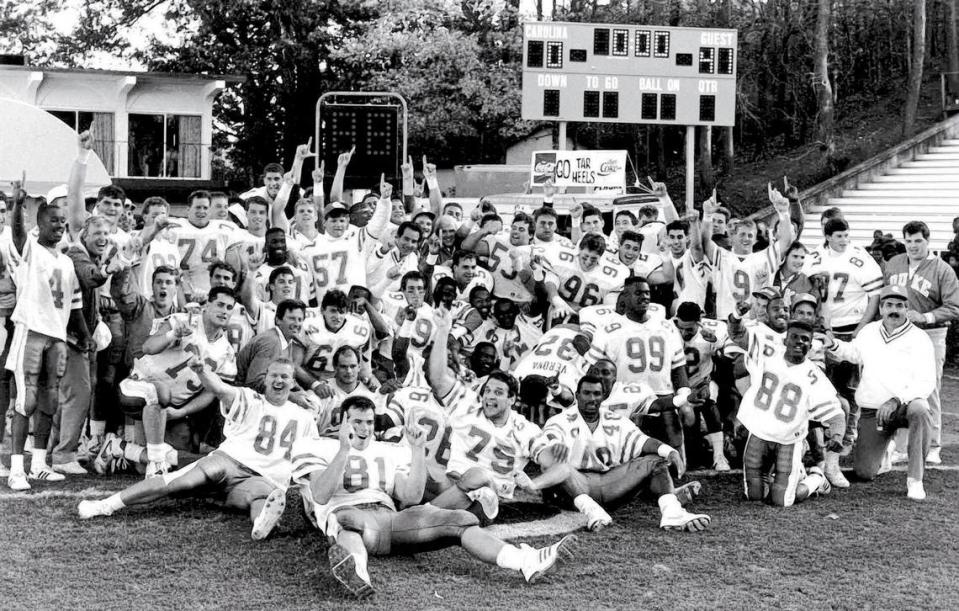 Duke football coach Steve Spurrier and his team posed in front of the scoreboard after defeating the UNC Tar Heels 41-0 in Kenan Stadium in 1989. The Blue Devils were celebrating a share of the 1989 ACC football championship.