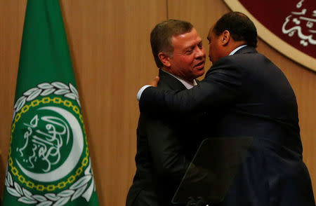 Jordan's King Abdullah II greets Sudan's President Omar Al Bashir (R) during the 28th Ordinary Summit of the Arab League at the Dead Sea, Jordan March 29, 2017. REUTERS/Mohammad Hamed