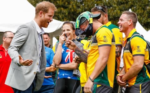 Prince Harry, Duke of Sussex joking around signing budgie smugglers on day two of the Invictus Games - Credit: Chris Jackson/Getty Images