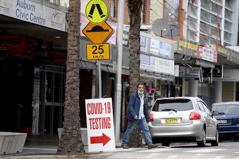 People are seen in Auburn, west of Sydney.