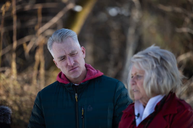 Chad Rasmussen, son of Jordan Rasmussen, listens as his aunt, Leslie Moore, remembers his father at Wasatch Lawn Memorial Park and Mortuary in Millcreek on March 5, 2023. | Ryan Sun, Deseret News