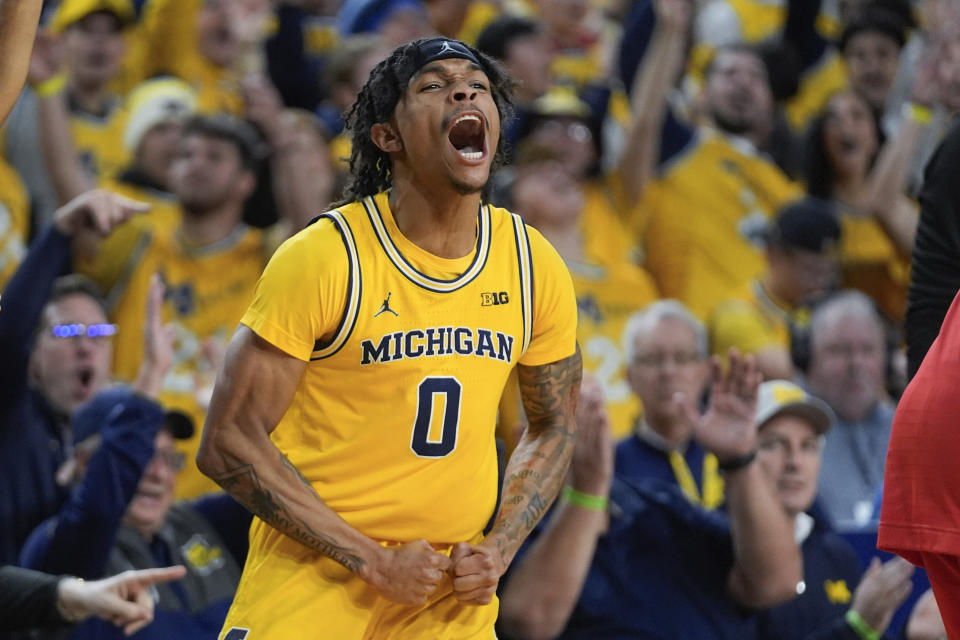 Michigan guard Dug McDaniel (0) reacts his three-point shot against Ohio State in the second half of an NCAA college basketball game in Ann Arbor, Mich., Monday, Jan. 15, 2024. (AP Photo/Paul Sancya)