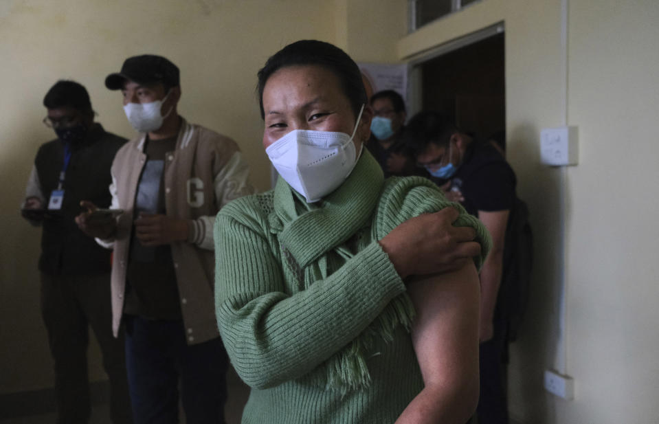 Shimray Wungreichon, 43, smiles into the camera after being administered the COVID-19 vaccine at the District Hospital in Ukhrul, in the northeastern Indian state of Manipur, Saturday, Jan. 16, 2021. Vaccine hesitancy has been a major concern as India started inoculating health workers Saturday in what is likely the world's largest COVID-19 vaccination campaign, joining the ranks of wealthier nations where the effort is already well underway. But Wungreichon is prepared. "As a health worker, this is a time when the world wants us to act,” she said.(AP Photo/Yirmiyan Arthur)