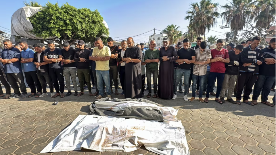 Mourners gather next to the bodies of Palestinians killed in Israeli strikes during a funeral at Al-Aqsa hospital in Deir el Balah, in central Gaza, on June 6. (Doaa Rouqa/Reuters)