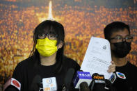 Chow Han Tung, vice chairwoman of the Hong Kong Alliance in Support of Patriotic Democratic Movements of China, shows a document from the police department during a news conference in Hong Kong, Sunday, Sept. 5, 2021. The group behind the annual Tiananmen Square memorial vigil in Hong Kong said Sunday it will not cooperate with police conducting a national security investigation into the group's activities, calling it an abuse of power. (AP Photo/Kin Cheung)