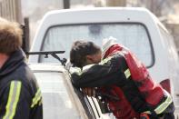 A rescue worker rests at the location where a forest fire burned several neighbourhoods in the hills in Valparaiso city, northwest of Santiago, April 13, 2014. At least 11 people were killed and 500 houses destroyed over the weekend by a fire that ripped through parts of Chilean port city Valparaiso, as authorities evacuated thousands and used aircraft to battle the blaze. REUTERS/Eliseo Fernandez (CHILE - Tags: SOCIETY ENVIRONMENT DISASTER)