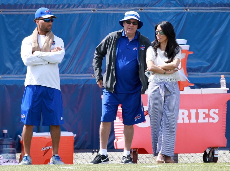 Better times: Doug Whaley, left, with Bills owners Terry and Kim Pegula last June. (AP)