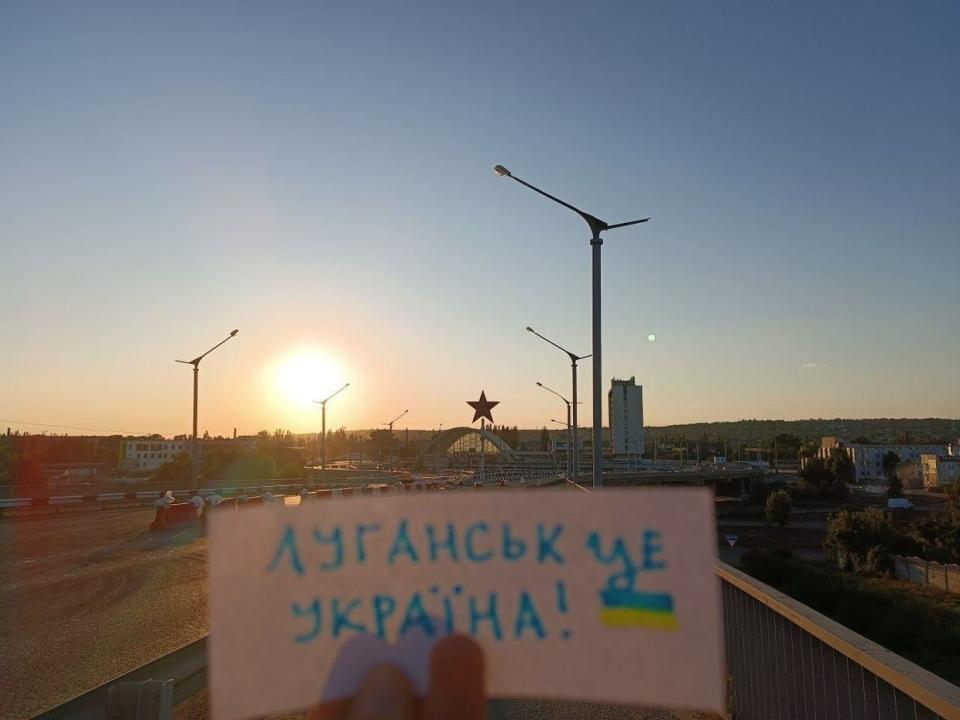 A photo of a paper sign saying "Luhansk is Ukraine!" taken near the railway station of occupied Luhansk, posted by Yellow Ribbon in August 2023. (Yellow Ribbon/Telegram)