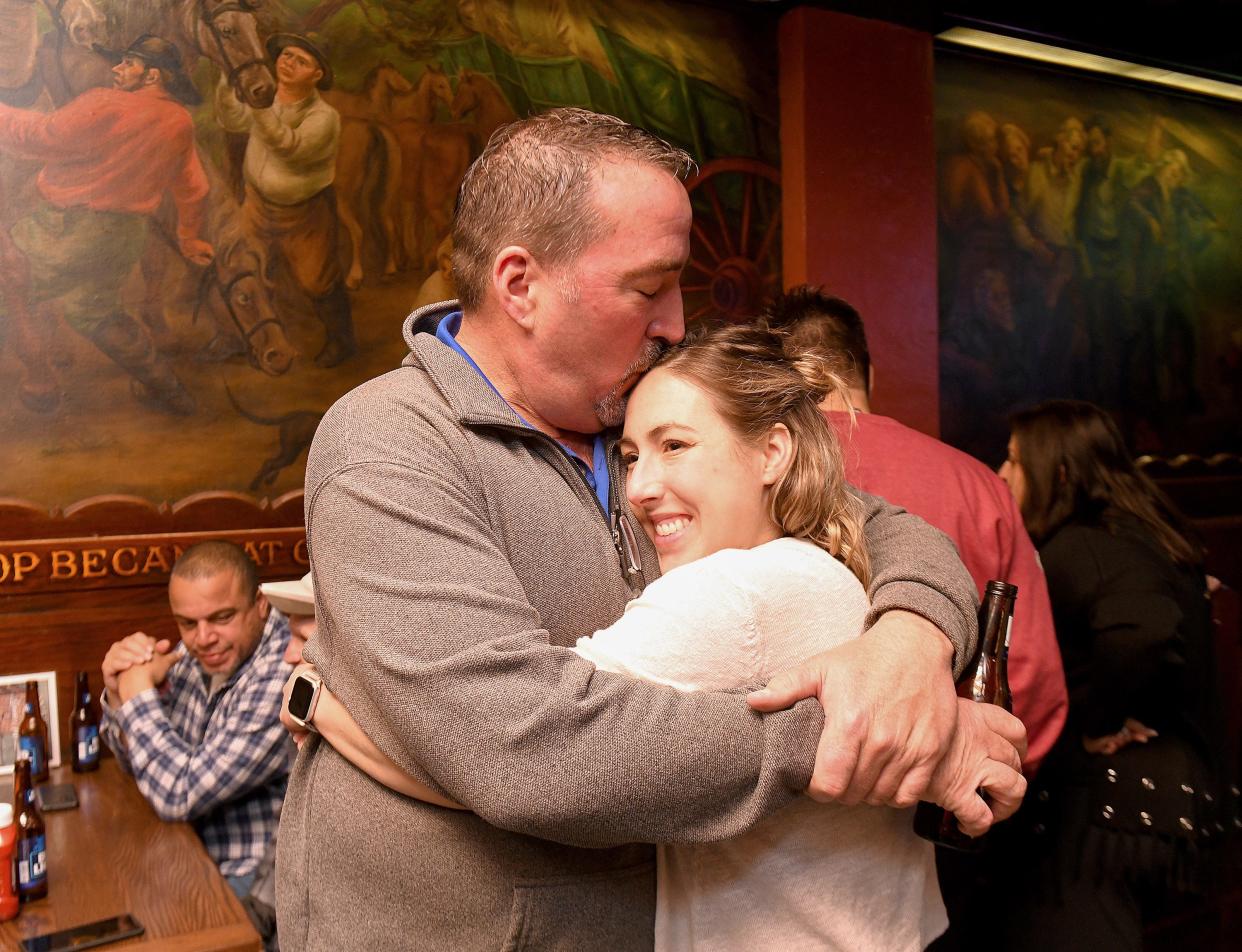 William V. Sherer II stops to kiss daughter, Nikki Carnahan of Canton, while greeting supporters as he waits for Democratic primary election day results for Canton mayor at Conestoga Grill.