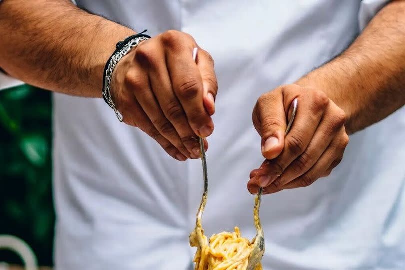 The carbonara pasta served in a giant cheese wheel