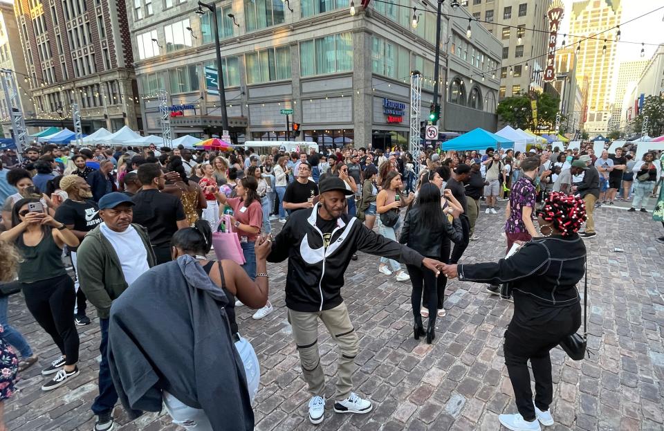 People dance at the Milwaukee Night Market on Wisconsin Avenue in the Westown neighborhood of Milwaukee on July 13.  The market made its full return this year and featured food, drinks, shopping and entertainment.