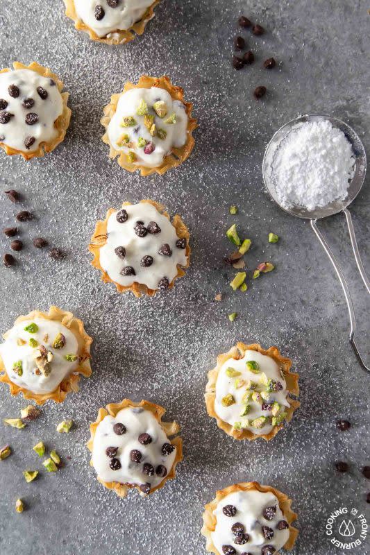 <p>Cooking on the Front Burners</p><p>These mini phyllo cannoli bites are a quick, easy and tasty little treat. The sweet ricotta filling is mixed with mini chocolate chip and nestled in a crispy shell that is topped with more chips or pistachios.</p><p><strong>Get the recipe: <a href="https://www.cookingonthefrontburners.com/mini-phyllo-cannoli-bites/" rel="nofollow noopener" target="_blank" data-ylk="slk:Mini Phyllo Cannoli Bites;elm:context_link;itc:0;sec:content-canvas" class="link rapid-noclick-resp"><em>Mini Phyllo Cannoli Bites</em></a></strong></p>