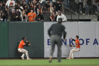 San Francisco Giants outfielders Michael Conforto, left, and Tyler Fitzgerald look for the ball on an inside-the-park home run by Cincinnati Reds' Stuart Fairchild during the eighth inning of a baseball game in San Francisco, Friday, May 10, 2024. (AP Photo/Jeff Chiu)