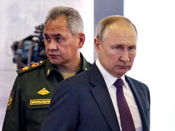 Russian President Vladimir Putin, right, and Russian Defense Minister Sergei Shoigu attend the launch of the construction of new nuclear submarines and other warships via video conference on the side of the International Military Technical Forum Army-2021 in Alabino, outside Moscow, Russia, Monday, Aug. 23, 2021.
