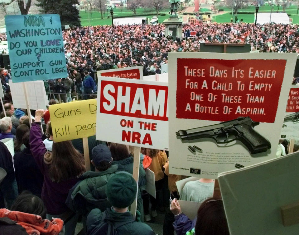 FILE - In this May 1, 1999, file photo, demonstrators gather on the Colorado State Capitol grounds in Denver, Colo., to protest against the National Rifle Association's annual meeting, which is being held in the city. Data shows that such shootings are less frequent and with fewer killed than in the years that preceded Columbine. Still, Americans worry about how safe schools are. (AP Photo/Eric Gay, File)