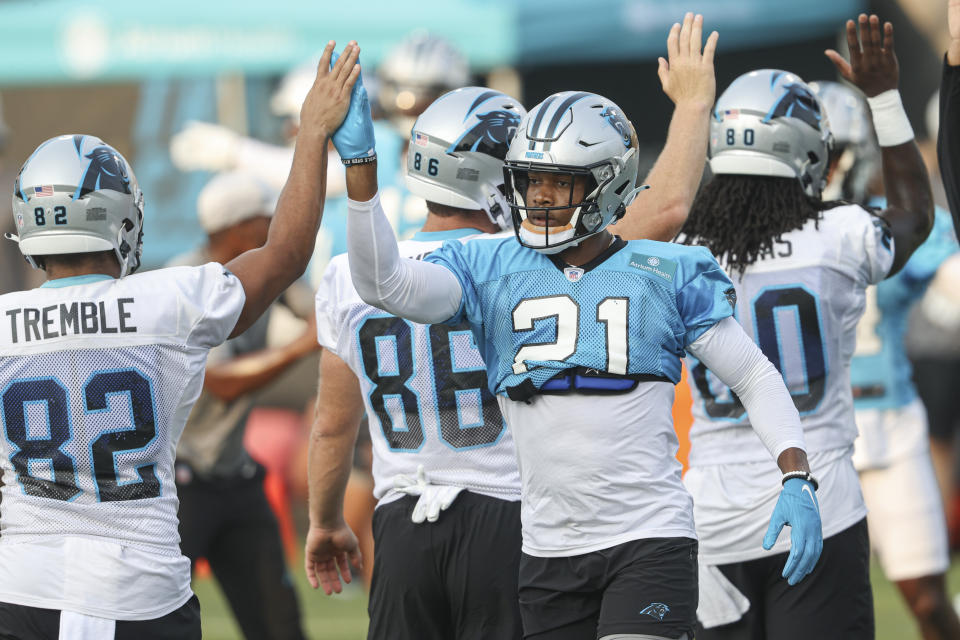 Carolina Panthers linebacker Jeremy Chinn (21) high-fives tight end Tommy Tremble (82) during practice at Back Together Saturday at the NFL football team's training camp in Spartanburg, S.C., Saturday, July 31, 2021. (AP Photo/Nell Redmond)