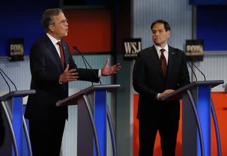 Republican U.S. presidential candidate and former Governor Jeb Bush (L) speaks as U.S. Senator Marco Rubio (R) looks on during the debate held by Fox Business Network for the top 2016 U.S. Republican presidential candidates in Milwaukee, Wisconsin, November 10, 2015. REUTERS/Jim Young