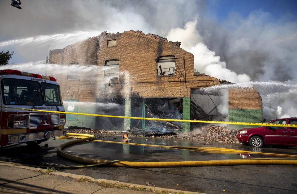 West Philadelphia Fire Department firefighters puts out a fire that broke Monday, Oct. 21, 2019, in Philadelphia. (Tyger Williams/The Philadelphia Inquirer via AP)