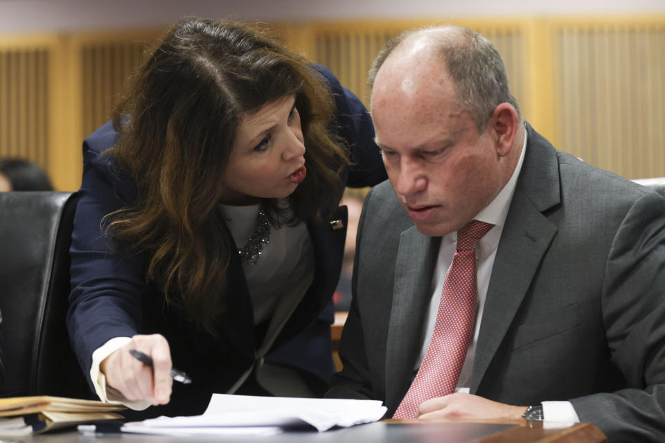 Fulton County Special prosecutor Anna Cross, left, who is representing the Fulton County District Attorney's office, speaks with attorney Andrew Evans, representing Fulton County Special Prosecutor Nathan Wade, during a hearing on the Georgia election interference case, Friday, Feb. 16, 2024, in Atlanta. The hearing is to determine whether Fulton County District Attorney Fani Willis should be removed from the case because of a relationship with Nathan Wade, special prosecutor she hired in the election interference case against former President Donald Trump. (Alyssa Pointer/Pool Photo via AP)