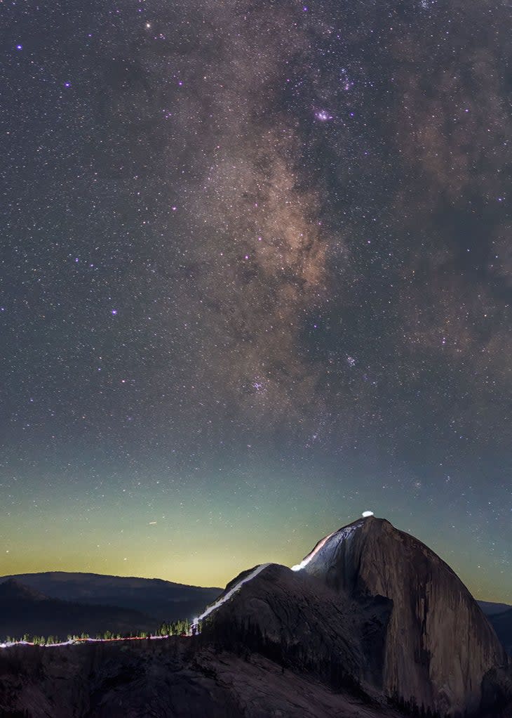 Milky Way over hikers on Half Dome in Yosemite.