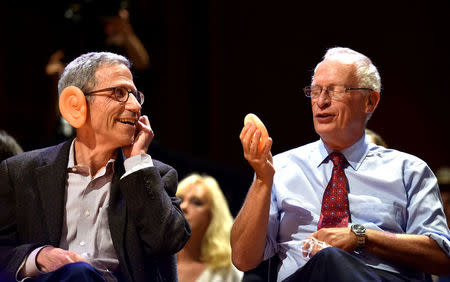 Eric Maskin, 2007 Nobel laureate in Economics, left, and Oliver Hart, 2016 Nobel laureate in Economics, try on plastic ears during the announcement that "Why Do Old Men Have Big Ears," won the Anatomy Prize during the 27th First Annual Ig Nobel Prize Ceremony at Harvard University in Cambridge, Massachusetts, U.S. September 14, 2017. REUTERS/Gretchen Ertl