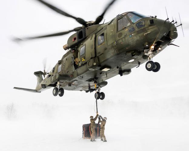 <p>Cargo is unloaded from a Merlin Mk3 helicopter in Norway (Si Ethell/MoD) </p>