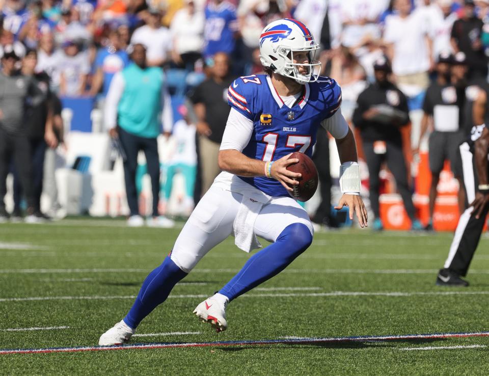 Bill quarterback Josh Allen runs out of the pocket and looks downfield against Miami.