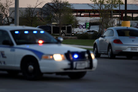 Schertz Police block off Doerr Lane near the scene of a blast at a FedEx facility in Schertz, Texas, U.S., March 20, 2018. REUTERS/Sergio Flores