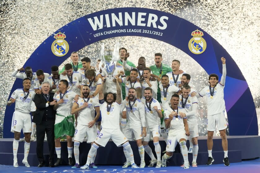 Real Madrid's Marcelo lifts the trophy after winning the Champions League final soccer.