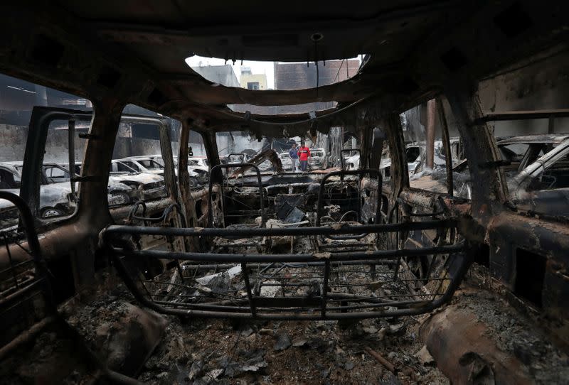 Burnt vehicles are pictured at a parking lot in a riot affected area following clashes between people demonstrating for and against a new citizenship law in New Delhi