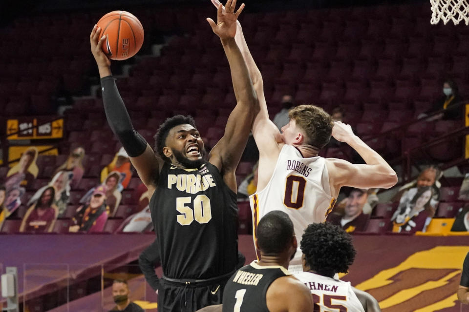 Purdue's Trevion Williams (50) shoots over Minnesota's Liam Robbins (0) in the second half of an NCAA college basketball game, Thursday, Feb. 11, 2021, in Minneapolis. (AP Photo/Jim Mone)