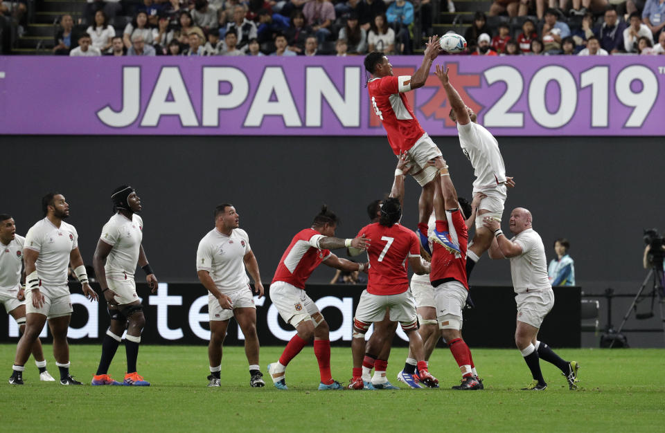 Tonga's Sam Lousi is held aloft as he wins a lineout during the Rugby World Cup Pool C game at Sapporo Dome between England and Tonga in Sapporo, Japan, Sunday, Sept. 22, 2019. (AP Photo/Aaron Favila)