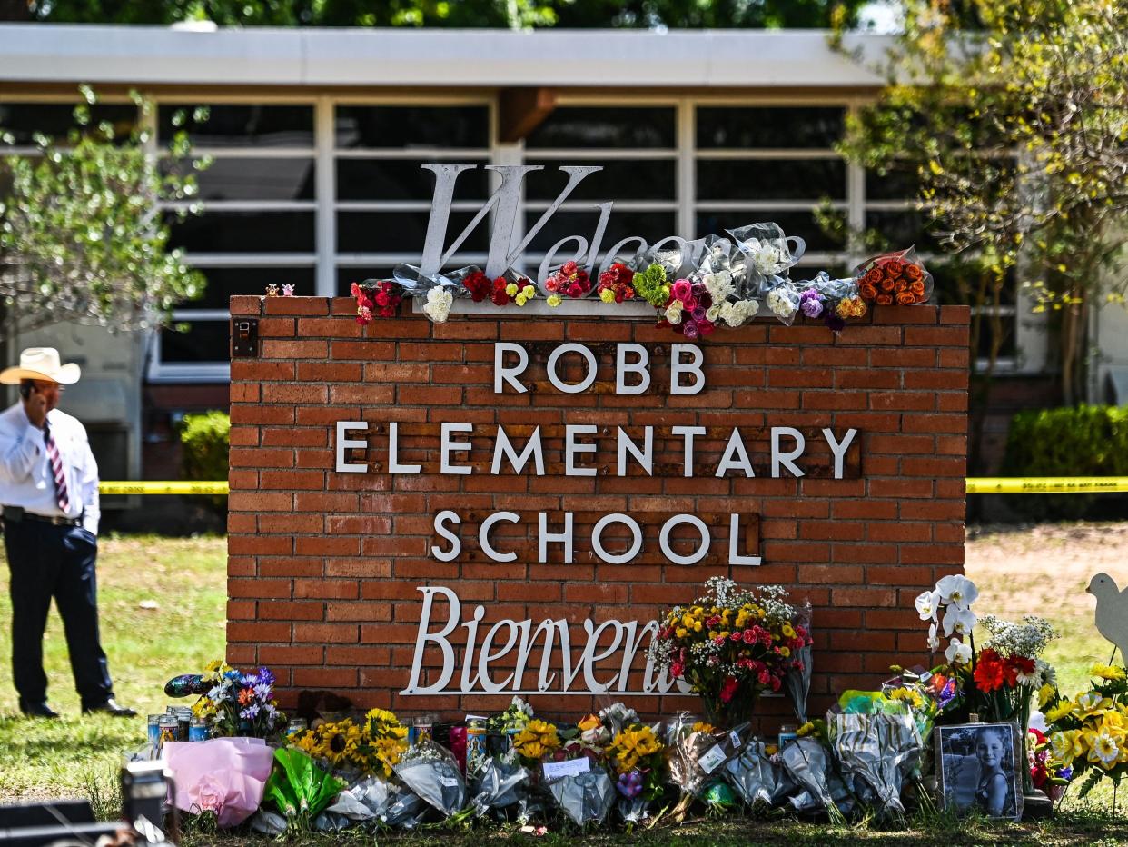 Flowers are placed on a makeshift memorial in front of Robb Elementary School in Uvalde, Texas, on May 25, 2022.