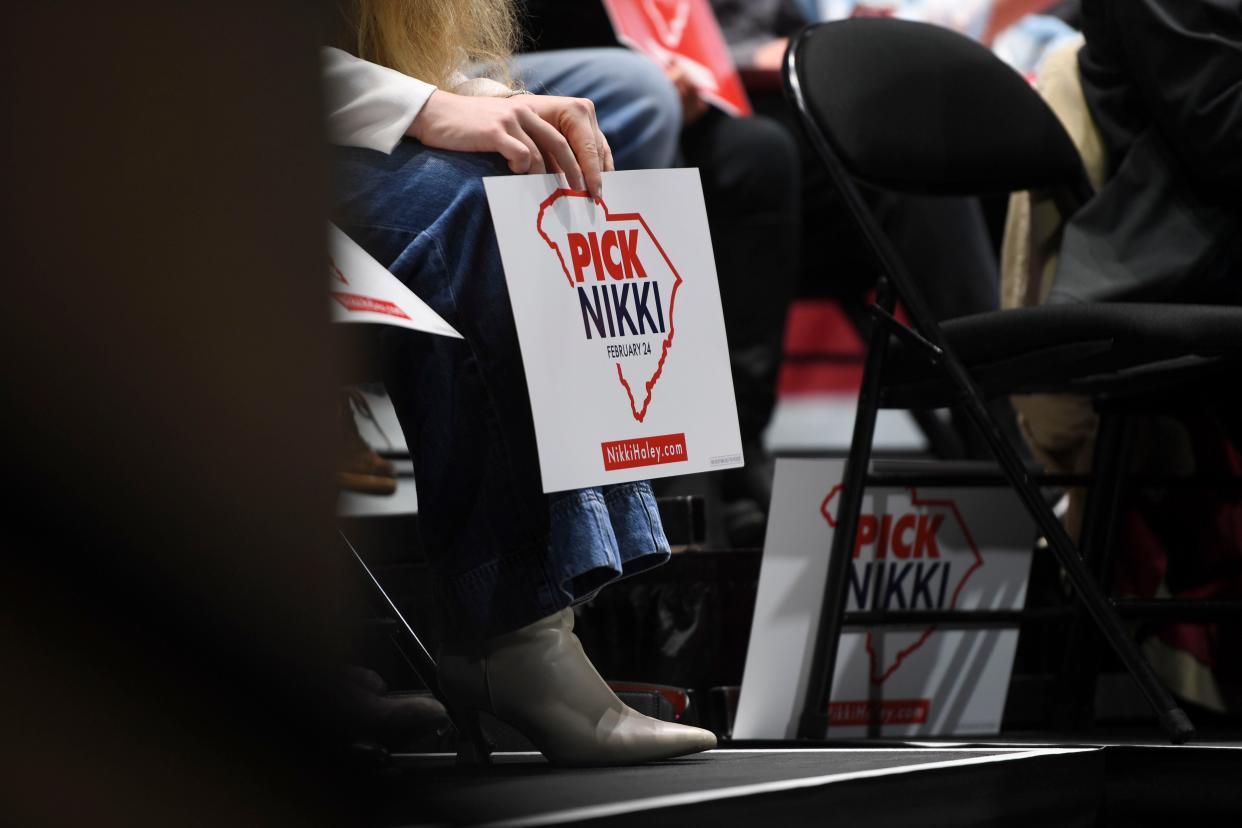 An audience member holds a "Pick Nikki" sign during presidential candidate Nikki Haley's meet and greet at The Etherredge Center at University of South Carolina Aiken on Monday, Feb. 5, 2024.