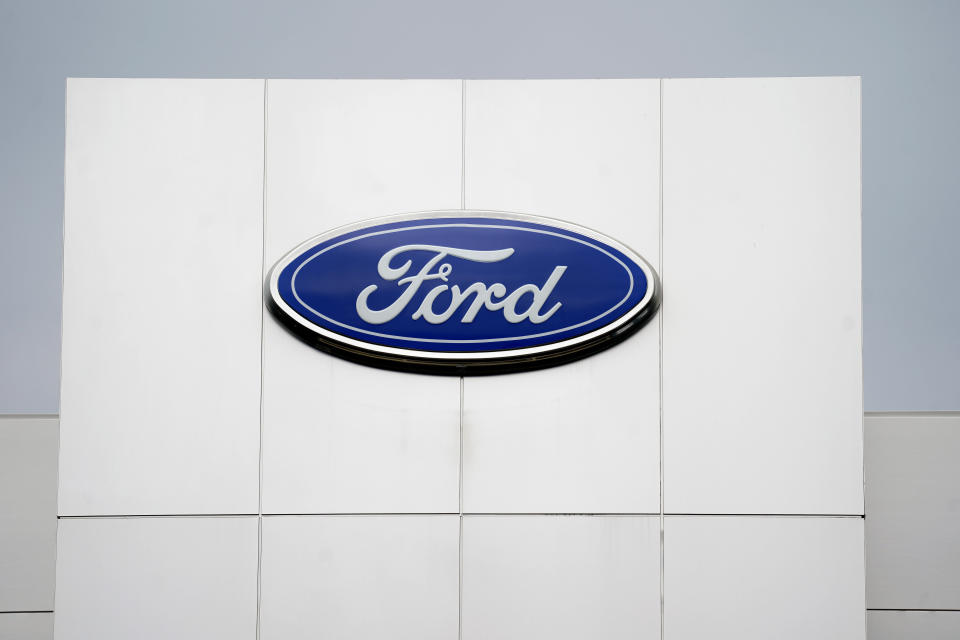 A Ford logo is seen on signage at Country Ford in Graham, N.C., Tuesday, July 27, 2021. Sky-high sales prices for its pickup trucks and SUVs helped Ford Motor Co. turn a surprise second-quarter profit despite a global shortage of computer chips that cut production. (AP Photo/Gerry Broome)