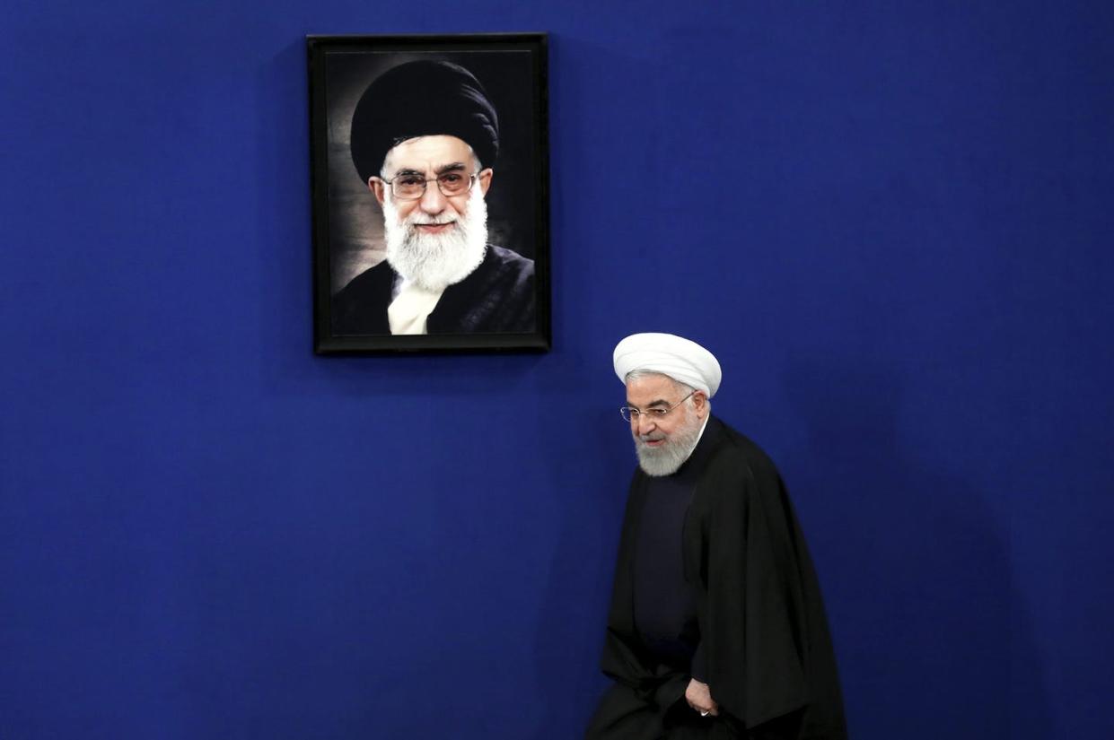 <span class="caption">Iran's President Hassan Rouhani arrives for a news conference in Tehran, Iran, in February 2020, with a portrait of the Supreme Leader Ayatollah Ali Khamenei hanging on the wall behind him. Both men have signalled an interest in a new nuclear deal. </span> <span class="attribution"><span class="source">(AP Photo/Ebrahim Noroozi)</span></span>