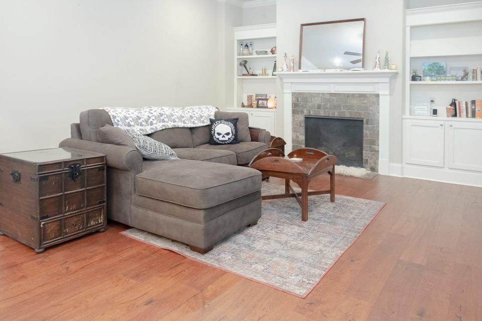 Comfortable furniture, plenty of shelves on both sides of the fireplace and a pleasing color palette add up to a much-enjoyed living room.