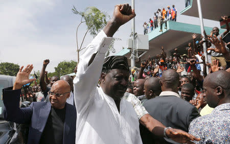 FILE PHOTO: Kenyan opposition leader Raila Odinga of NASA coalition escorted by businessman Jimi Wanjigi, gestures before a swearing-in ceremony as the president of the People's Assembly in Nairobi, Kenya January 30, 2018. REUTERS/Thomas Mukoya