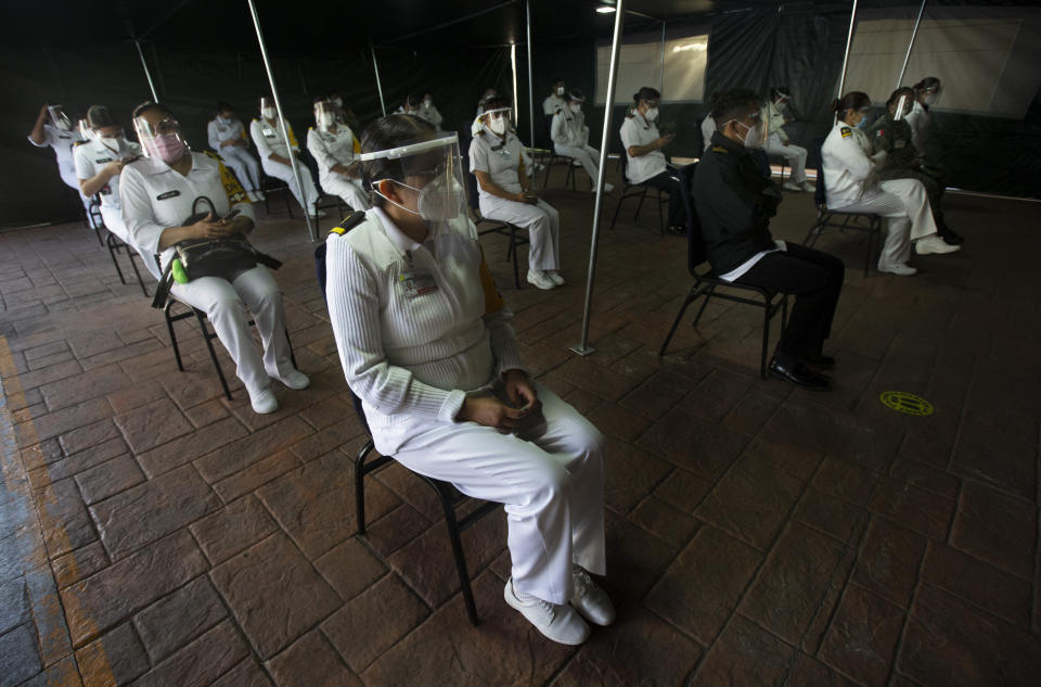 Mexican army health workers wait to be vaccinated against COVID-19 at the Central Military Hospital in Mexico City, on Tuesday, Dec. 29, 2020. (AP Photo/Marco Ugarte)