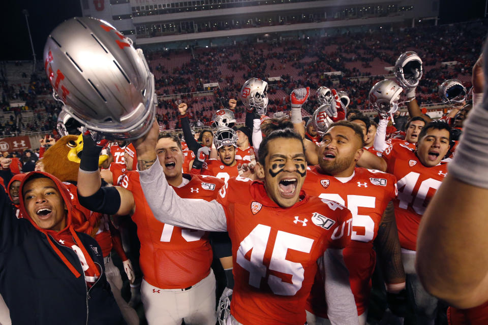 Utah wide receiver Samson Nacua (45) celebrates with his teammates after their victory over Colorado during an NCAA college football game Saturday, Nov. 30, 2019, in Salt Lake City. (AP Photo/Rick Bowmer)