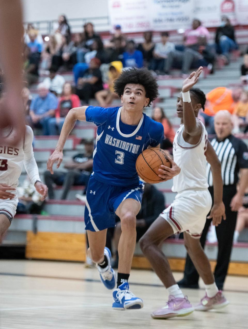 Alex Jasquith (3) drives to the hoop during the Booker T. Washington vs Tate boys basketball game at Tate High School on Thursday, Dec. 8, 2022.